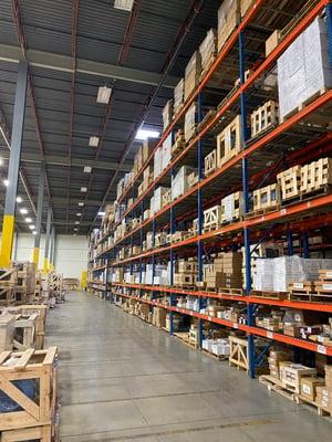 Aisle of racking in a warehouse showing small crate storage