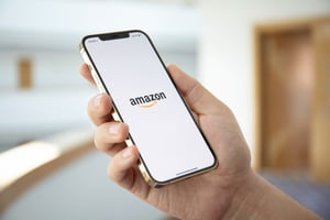 Person Using Amazon App on Smartphone - Smart Warehousing