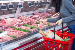 Woman Shopping from Fresh Beef Display at Supermarket - Smart Warehousing