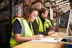 Warehouse Staff Filling Out Paperwork - Smart Warehousing